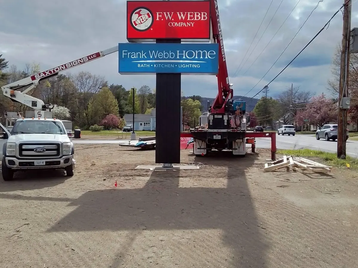 Saxton Signs bucket truck and crane installing the F.W. Webb pylon sign