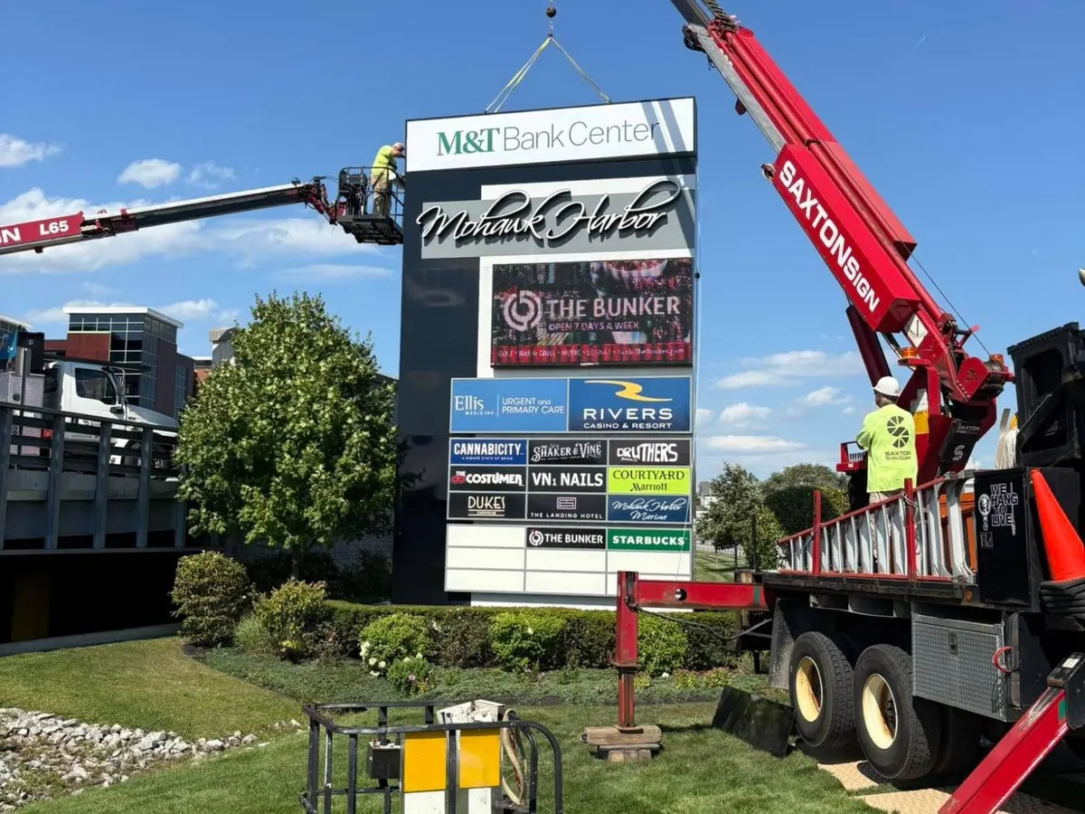 Saxton Signs crane installing the Mohawk Harbor multi-tenant pylon sign with tenant panels